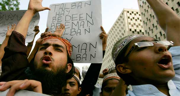 People chant slogans against the Taliban at a rally in Karachi. - AP